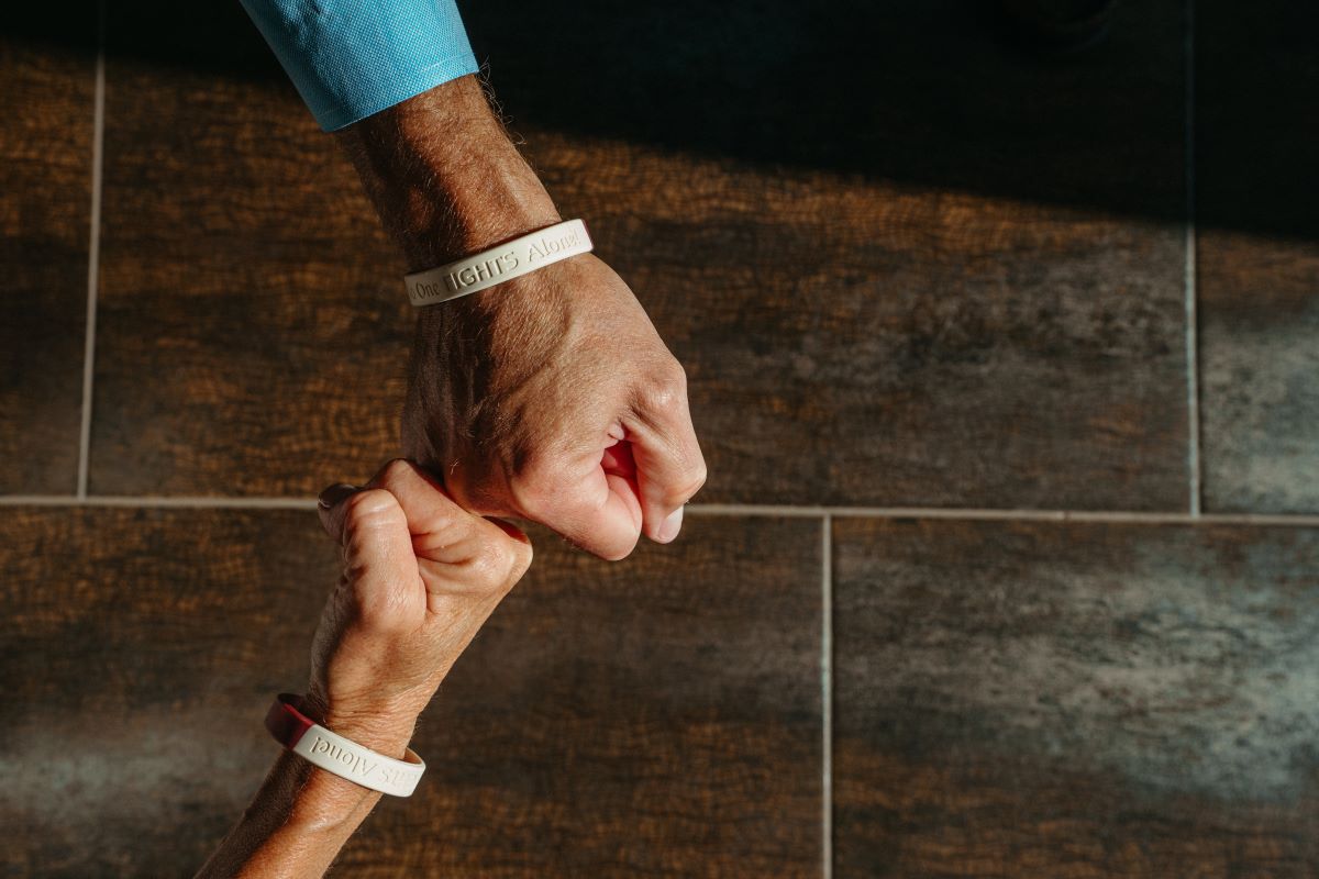 Joe’s family members all wear bracelets stamped “No one fights alone.”